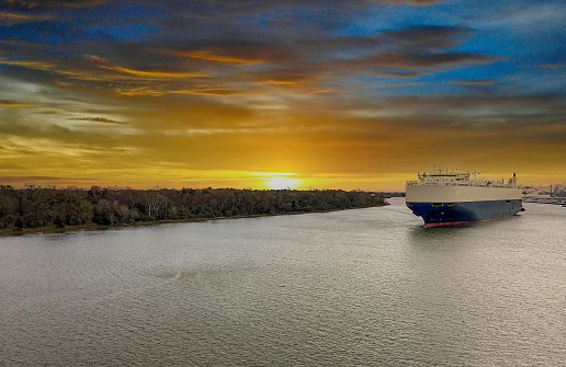 A Tanker makes its way to port on the Savannah River at sunrise in Savannah, Georgia