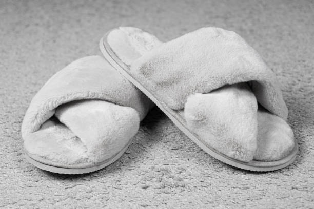 istock Modern Stylish Fluffy Grey House Slippers On Carpet 1890205874