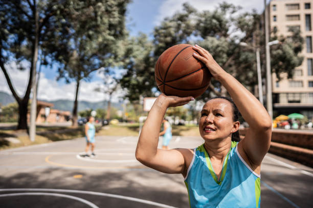 istock Mature woman playing basketball 1890211532