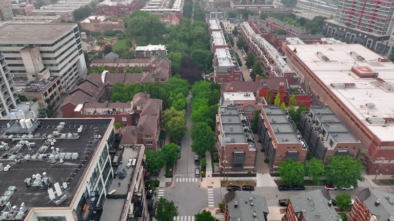 Urban landscape with high-rise buildings and tree-lined streets. Aerial establishing shot.