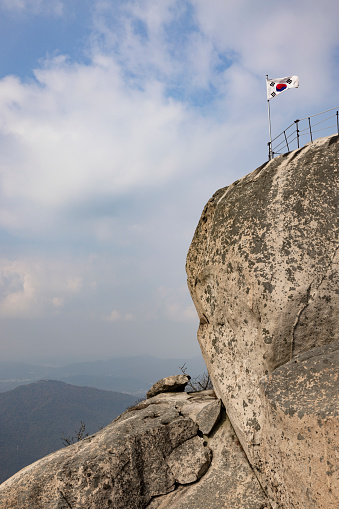 korea national flag at baegundae mountain peak, south korea.