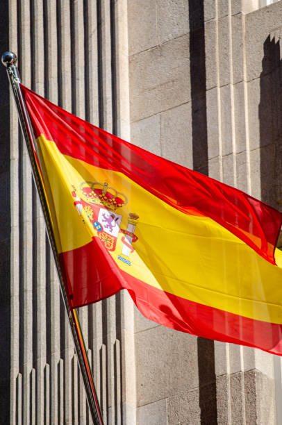 istock flag of spain waving on a building facade 1890252780