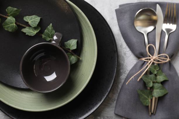 istock Stylish table setting. Dishes, cutlery, napkin and floral decor, top view 1890326133