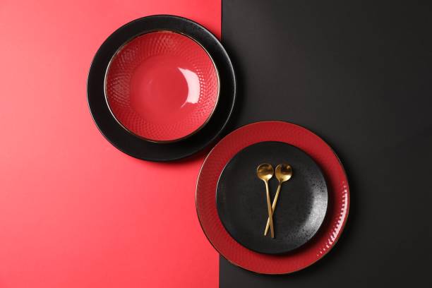 istock Stylish table setting with plates and spoons on color background, top view 1890330395