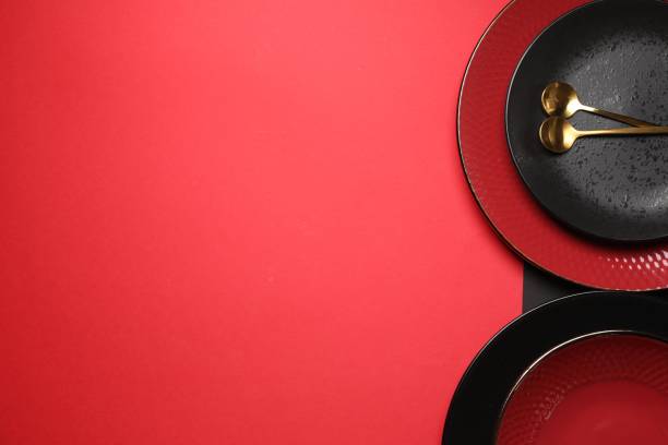 istock Stylish table setting with plates and spoons on color background, top view. Space for text 1890330903