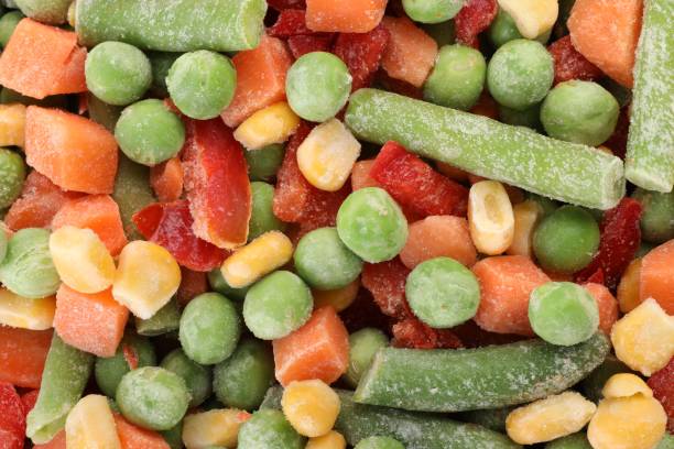 istock Mix of different frozen vegetables as background, top view 1890342639