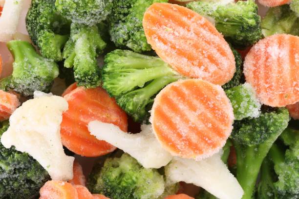 istock Mix of different frozen vegetables as background, top view 1890343713