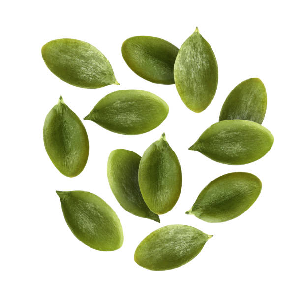 istock Peeled pumpkin seeds falling on white background 1890355044