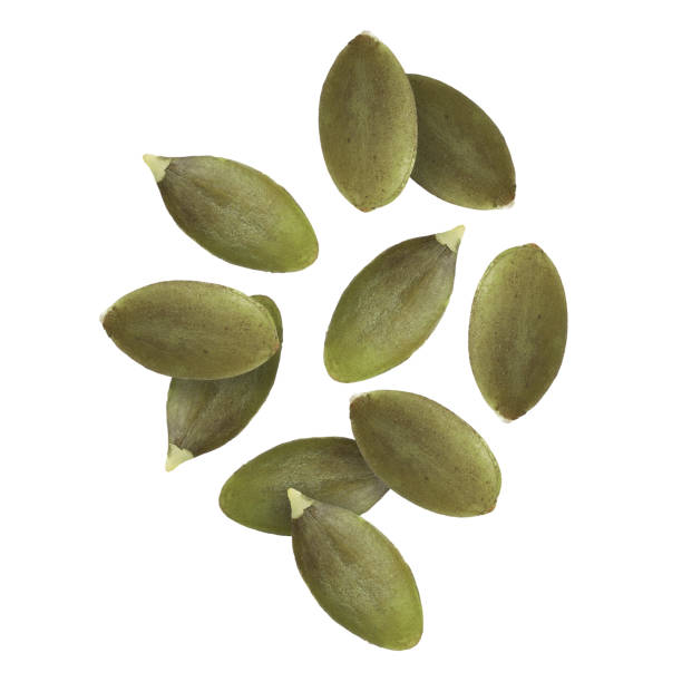 istock Peeled pumpkin seeds falling on white background 1890356135
