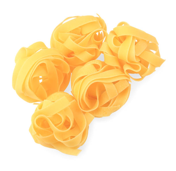 istock Raw fettuccine pasta isolated on white, top view 1890373616