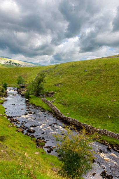 istock Storm clouds gathering over a small river cascading over rocks in the Yorkshire Dales National Park, England. 1890376201