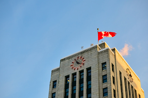 Below view Vancouver City Hall with Canadian flag.  Copy space.