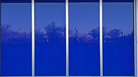 The view reflected in the blue coloured windows of a building.