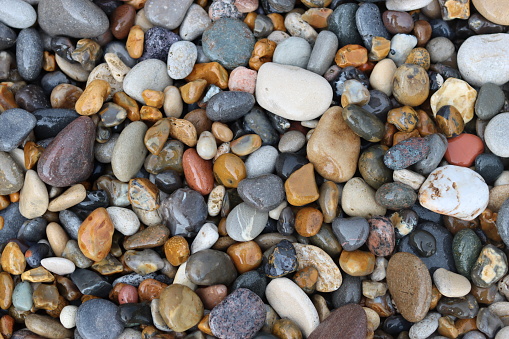 Close up of smooth stones and pebbles on a beach