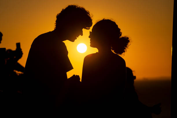 istock Young couple in silhouette, in late afternoon. 1890424895