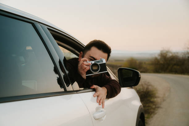 istock Man taking a photo from a car window 1890442838