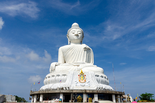 The Big Buddha statue located on Phuket Island, Thailand. This iconic landmark, known as the Great Buddha of Phuket, sits atop Nakkerd Hill near Chalong and is visible from far away due to its large size and elevation. The statue is a significant religious site and a popular tourist attraction, offering panoramic views of the island.