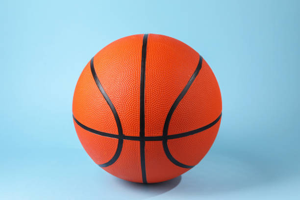 istock One orange basketball ball on light blue background 1890473814