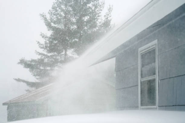 istock strong wind blowing snow off the roof in blizzard 1890479143