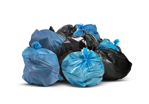 Pile of plastic bags full of garbage on white background