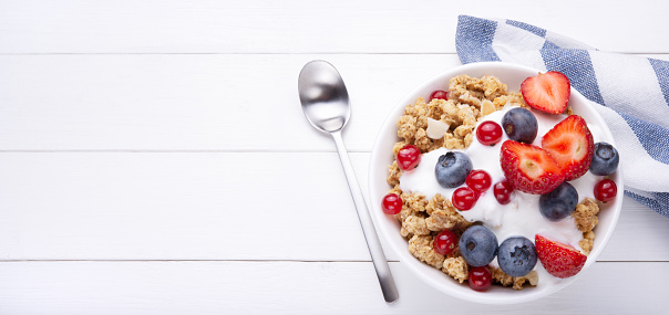 Breakfast with cereals and fresh berries, flat lay.