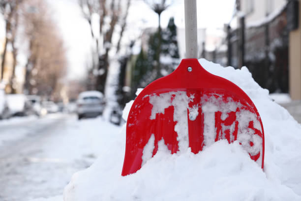 istock Snow shovel with wooden handle outdoors. Space for text 1890495780