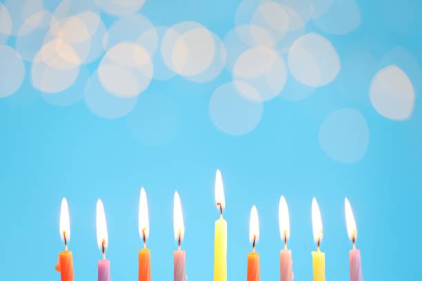 istock Hanukkah celebration. Burning candles on light blue background with blurred lights, space for text 1890508768
