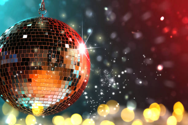 istock Shiny disco ball on color background with blurred lights, space for text. Bokeh effect 1890518532