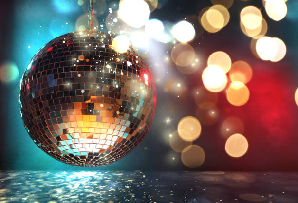 istock Shiny disco ball under golden lights on color background, space for text. Bokeh effect 1890519660