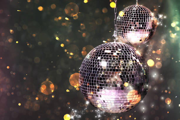istock Shiny disco balls on dark background with blurred lights, space for text. Bokeh effect 1890519662