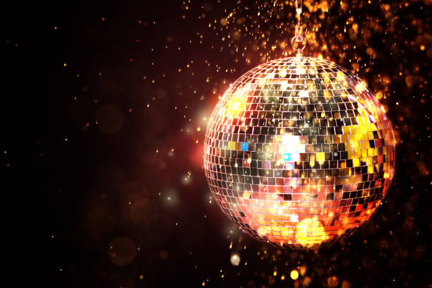 istock Shiny disco ball under golden lights on dark background, space for text. Bokeh effect 1890521646