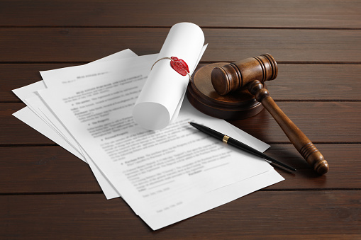 Notary contract. Documents, gavel and pen on wooden table