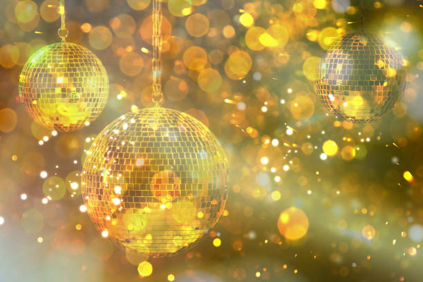 istock Shiny bright disco balls under golden lights, bokeh effect 1890522278