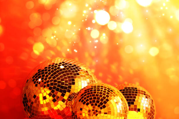 istock Shiny disco balls under golden lights, bokeh effect 1890523312