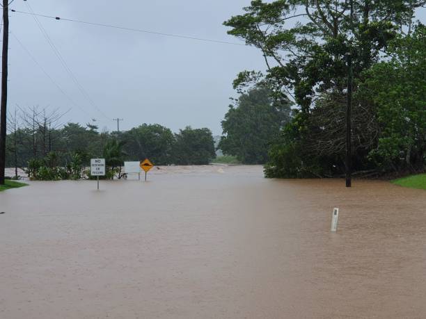 North Johnstone River Flooding Innisfail Queensland Recent flooding in Far North Queensland Australia from Ex-Tropical Cyclone Jasper. Heavy rains descended from the heavens, obliterating large parcels of land and residential areas with nearly a meter of rain over 4 days. The photo here, is the McAvoy Bridge and adjoining light cane train rail bridge on the North Johnstone River, inundated with nearly 7.5mtr high flood waters. All that can be seen is the road signs and nothing else. queensland floods stock pictures, royalty-free photos & images