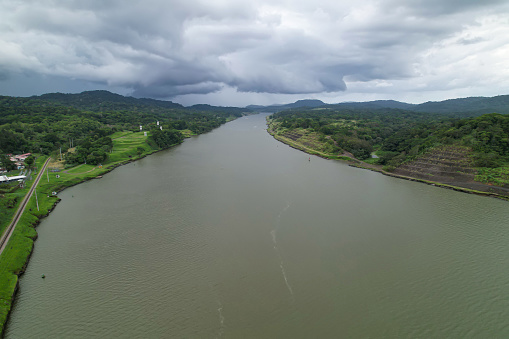 Artificial waterway of Panama Canal connecting Pacific and Atlantic oceans. Strategic man-made water shortcut divides Central and South America and enables shortening of routes for maritime traffic.