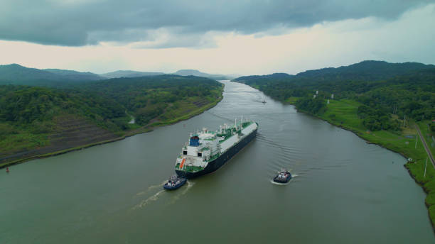 istock Escorted cargo ship travels between two oceans through Panama Canal waterway 1890553777