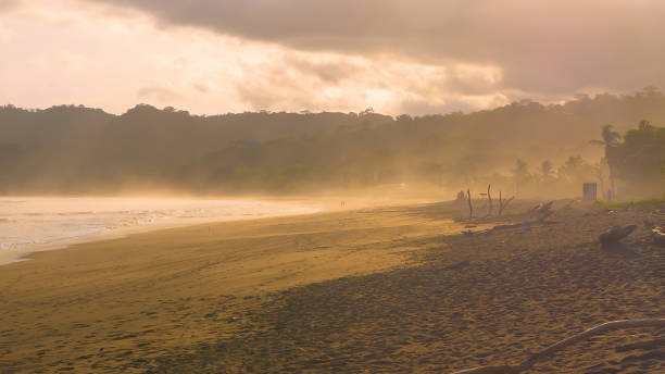 istock Rain cloud rolling over beautiful beach at Playa Venao in golden sunset light 1890561284