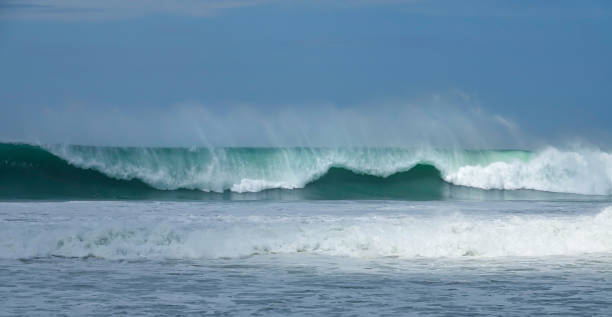 istock Cleanup set with an amazing blue closeout wave breaking along Pacific coastline 1890561796