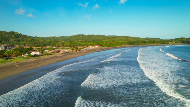 AERIAL: Incredible view of tropical beach with deep blue rolling ocean waves