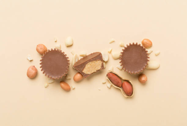 istock Tasty chocolate peanut butter cups on color background, top view 1890567678