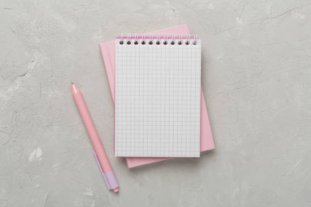 istock Notebooks with stationery on concrete background, top view 1890578020