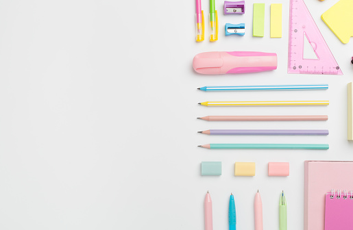 Flat lay with colorful school stationery on white backgroung, top view