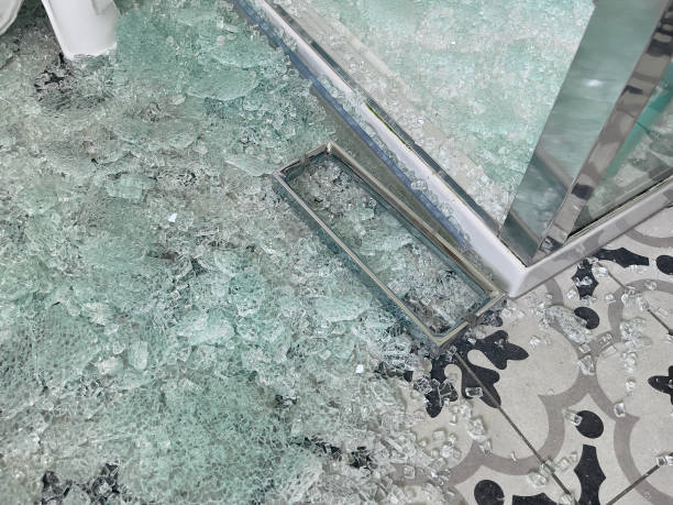 istock Broken glass shower door with chrome handle in a tiled bathroom 1890581143
