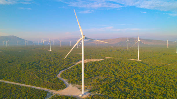 istock AERIAL: Wind park with scattered windmills in beautiful Adriatic countryside 1890587394