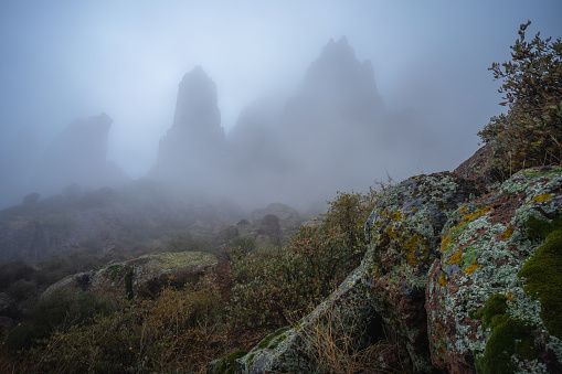 Morning fog hangs over the rugged landscape of the Superstition Mountains after a winter storm in Lost Dutchman State Park in Apache Junction, AZ