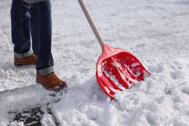 istock Man shoveling snow outdoors on sunny day, closeup 1890627303