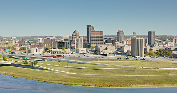 Aerial still of Interstate 75 and downtown Dayton, Ohio, on a clear day in Fall.