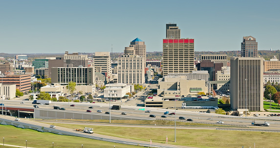 Aerial still of Interstate 75 and downtown Dayton, Ohio, on a clear day in Fall.