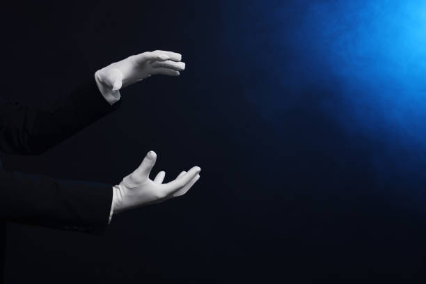 istock Magician holding something on dark background, closeup. Space for text 1890653179